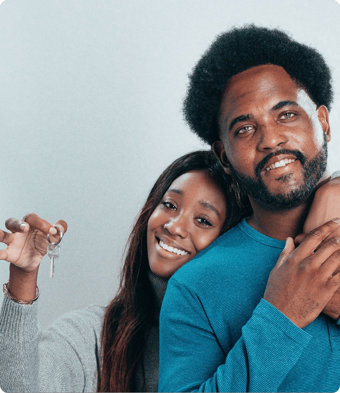 A couple holding the keys to their home
