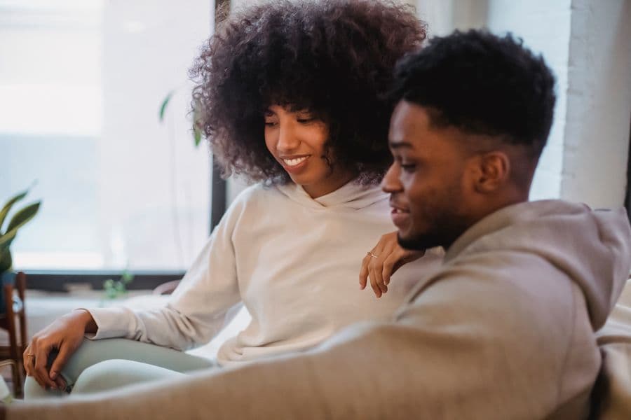 A happy couple relaxing together at home
